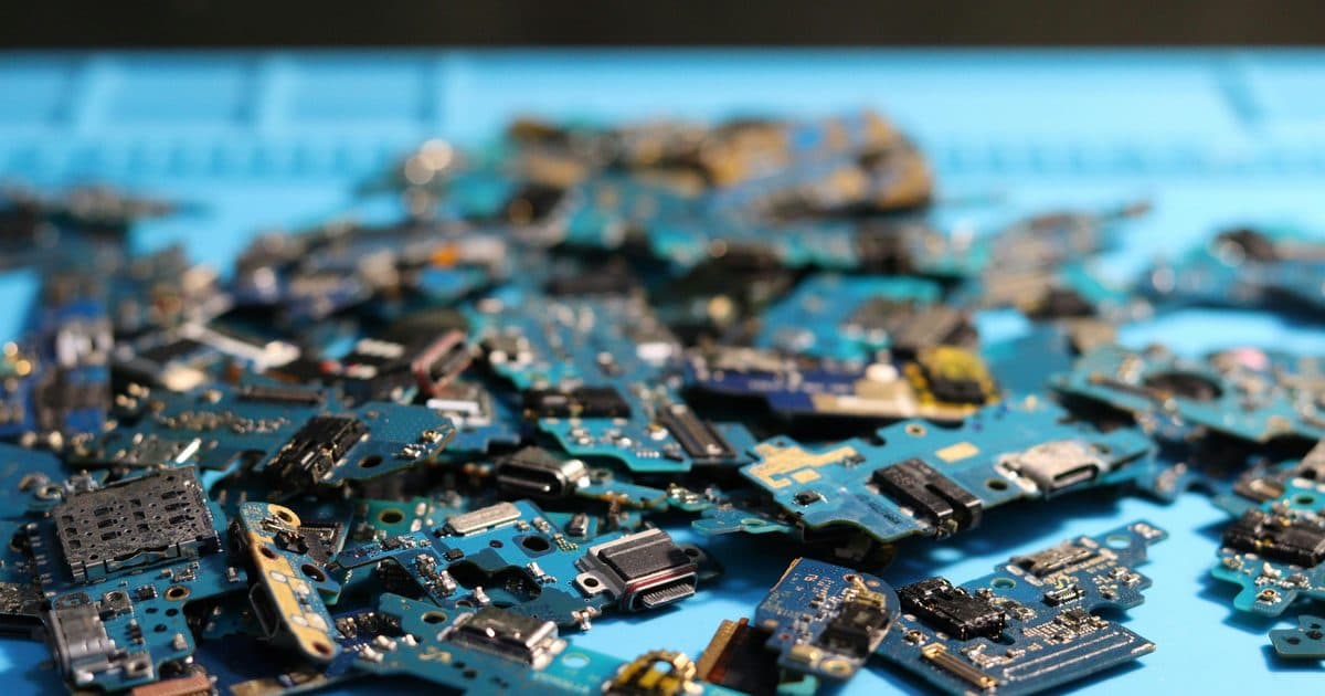 Assorted electronic components and circuit boards spread across a work surface
